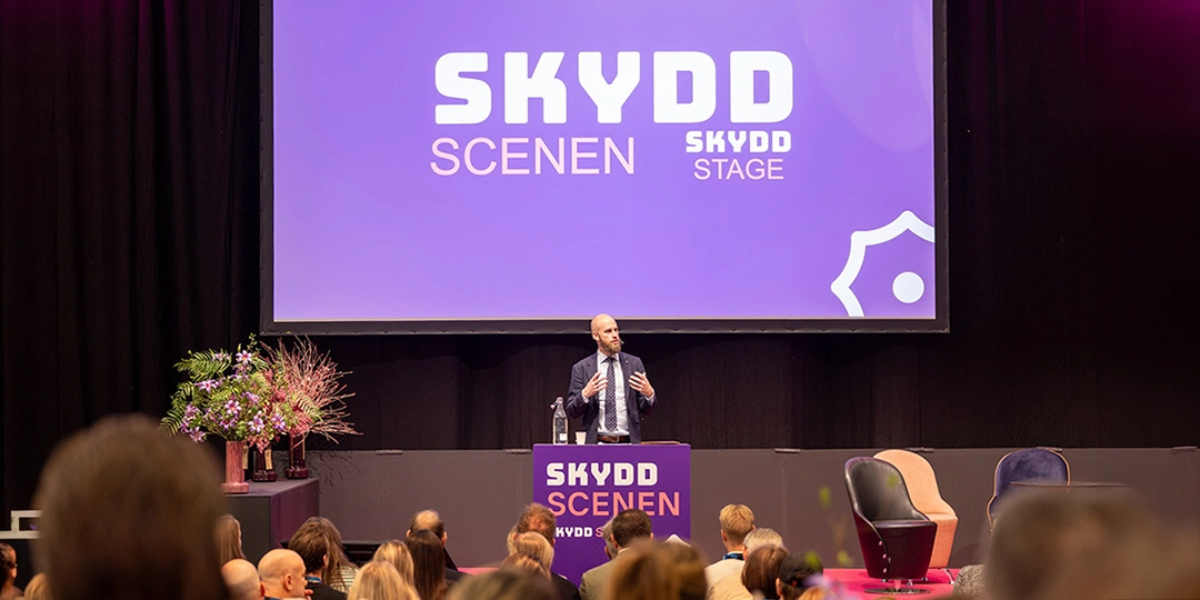 carl-oskar-bohlin-SKYDD Carl-Oskar Bohlin, minister för civilt försvar, talar på SKYDD-scenen inför en sittande publik under säkerhetsmässan SKYDD.